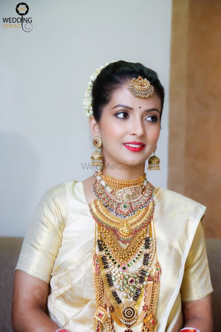 South Indian bride with multiple layered necklaces