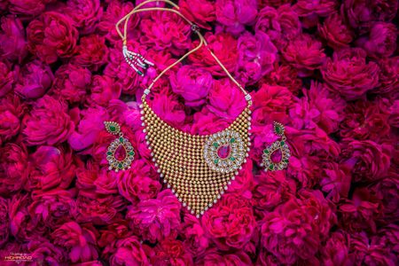 Bridal necklace and earrings with floral backdrop