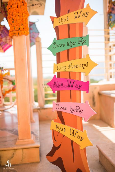 Photo of Mehendi or wedding decor with cute direction boards