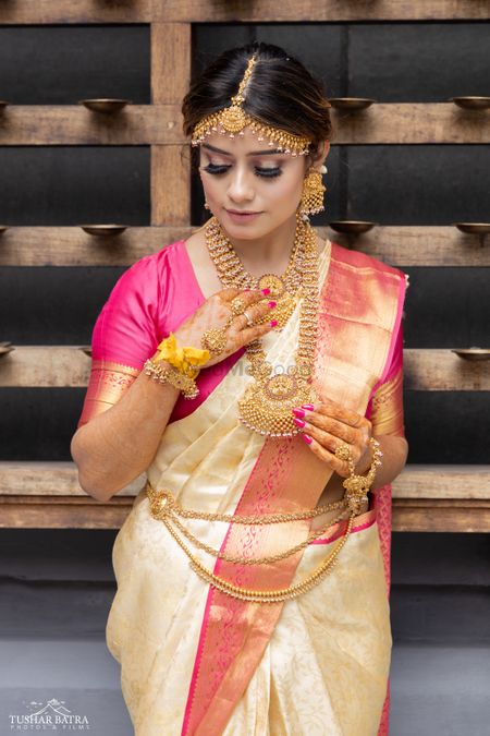 Beautiful South-Indian bride Isha looking radiant in her pastel saree and some stunning traditional jewellery captured by Tushar Batra Films.
