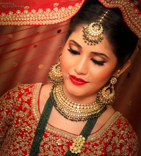 Pretty bride in red and gold