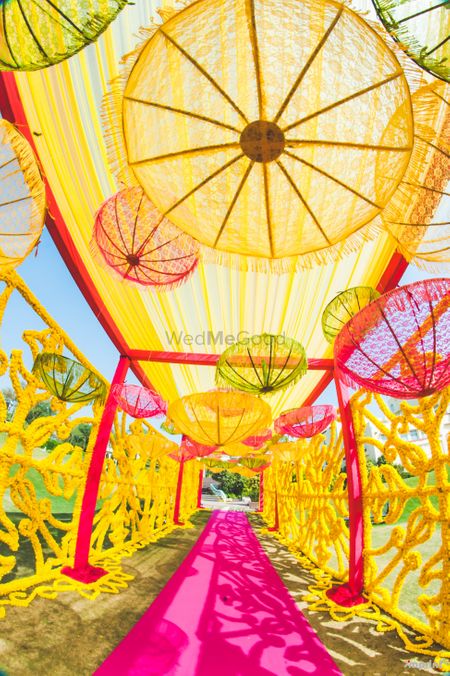 Hanging umbrellas in yellow and pink for mehendi entrance decor