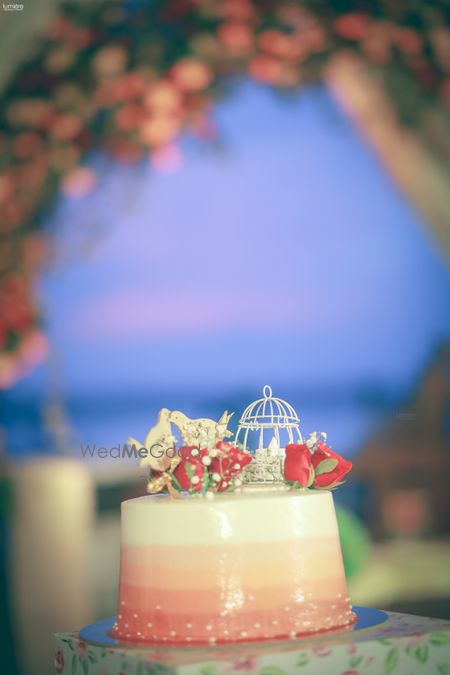 Photo of small wedding cake with cute elements on top