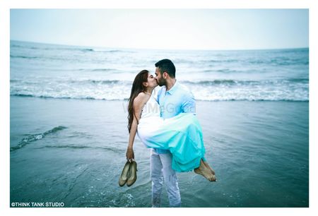 Photo of Romantic couple kissing on beach shot