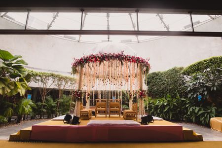 Mandap decor idea with floral dome and hanging strings