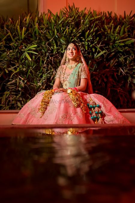 Light pink and green lehenga with contrasting tassels 