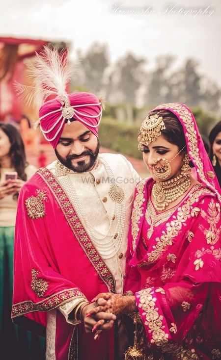 Bride and groom in bright pink outfits