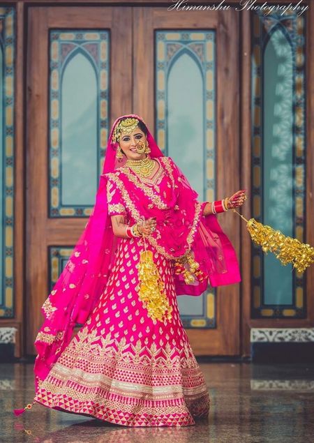 Bride in bright pink lehenga with kaleere