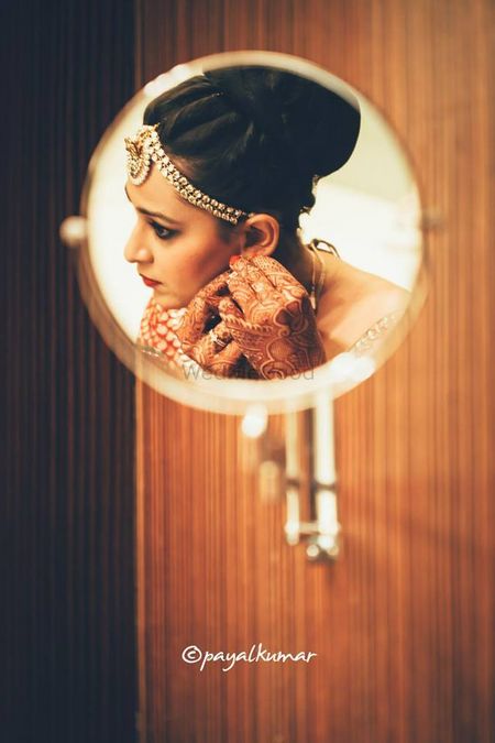 Bride reflection in mirror while getting ready