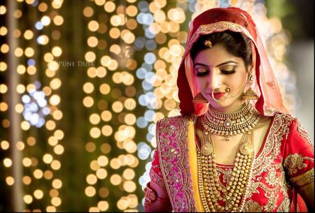 Red Bride Portrait with Fairy Lights Backdrop