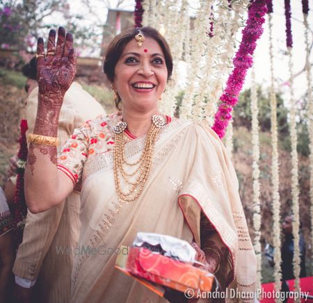 Mother of the bride in white saree