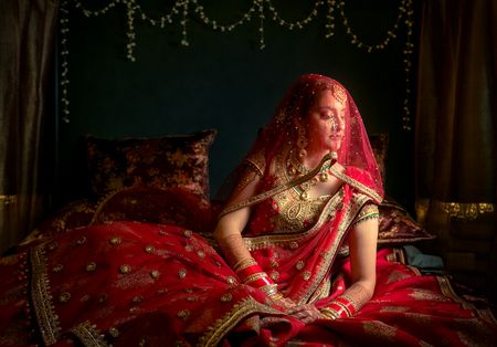 Bridal portrait in red with dupatta as veil