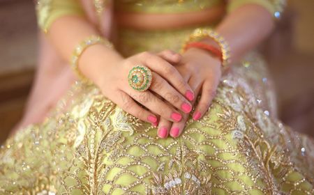 Bright pink nails with cocktail ring