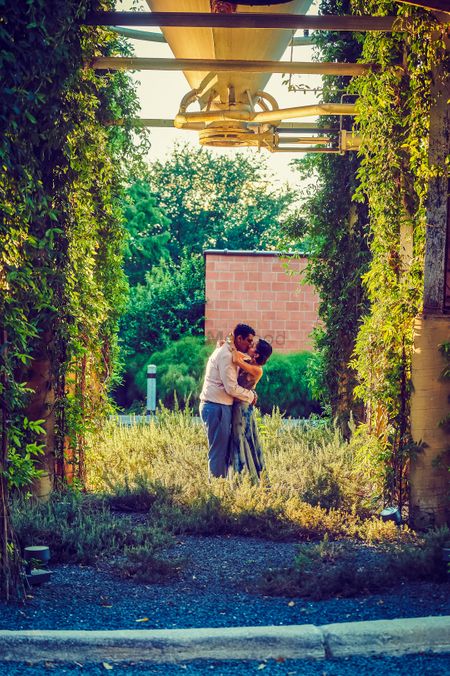 Outdoor pre wedding shoot with couple kissing shot