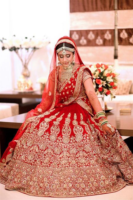 Red and gold flared out bridal lehenga portrait