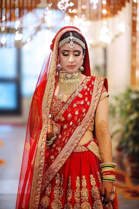 Bride in red and gold lehenga with double dupatta
