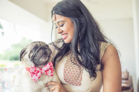 Photo of Bride with dog wearing bow tie