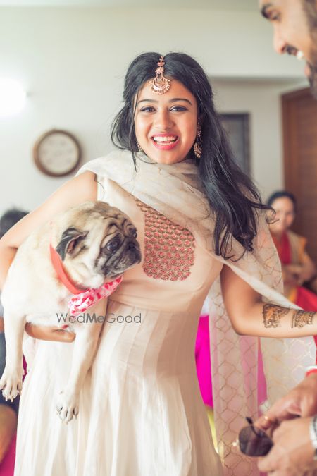 Photo of Bride with pet pug on mehendi