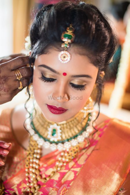 Photo of South Indian bridal makeup with gold eyes and red lips