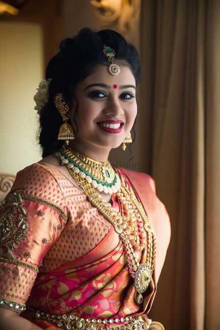 Photo of South Indian bride in red gold and pink saree