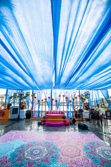 Photo of Mehendi decor with printed dance floor in blue and pink