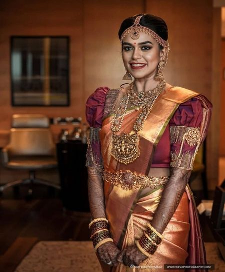 Gold kanjivaram bride with temple jewellery and unique blouse