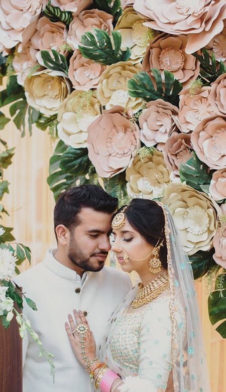 Romantic couple shot against giant paper flowers