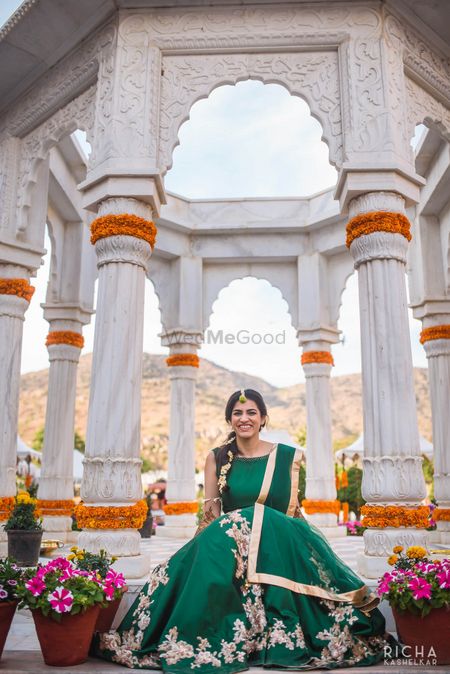 Photo of Dark green lehenga with floral embroidery for mehendi