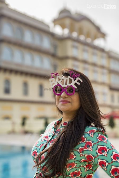 Photo of Bride wearing prop glasses