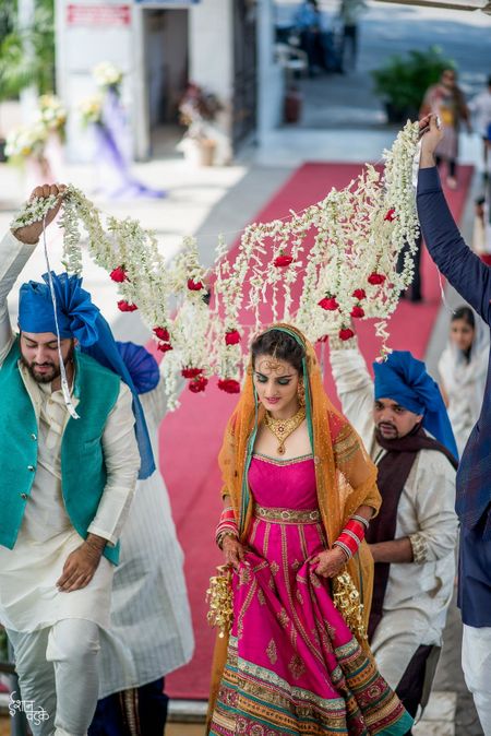 Bride entering wearing pink Anarkali 