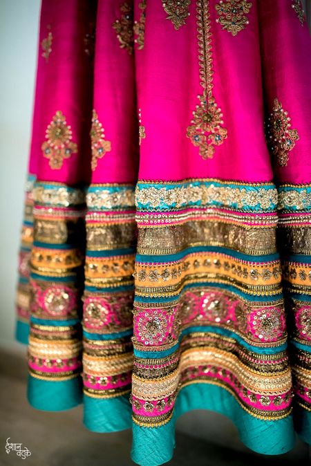 Photo of Bright pink and turquoise lehenga with broad border