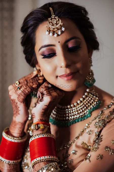 Candid shot of a bride wearing her earrings.