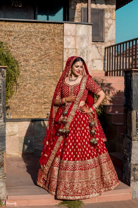 Red and gold bridal lehenga with unique latkan 