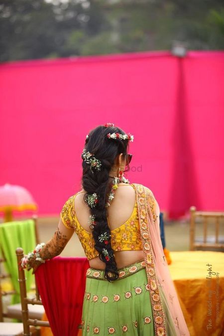 Photo of Princess braid with small flowers for mehendi