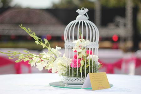 birdcage with floral arrangements
