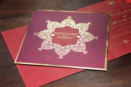 Photo of purple and red wedding card