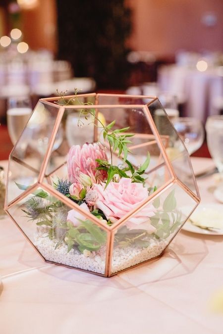Brass and glass terrarium with flowers