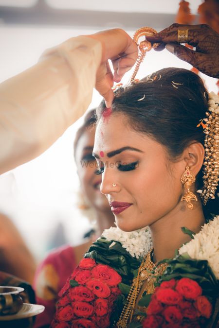 A south Indian bride getting sindoor in her head