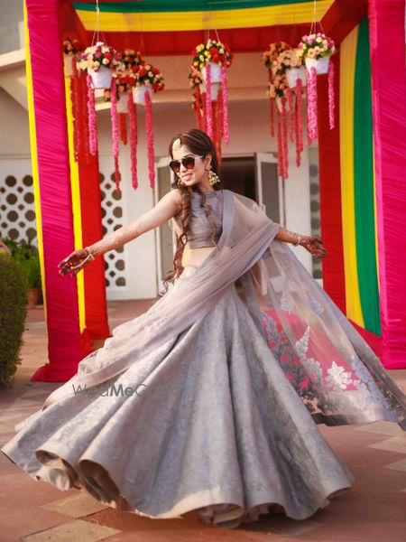 Light grey and pin lehenga bride twirling 