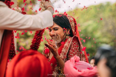 Happy bride in red during jaimala shot