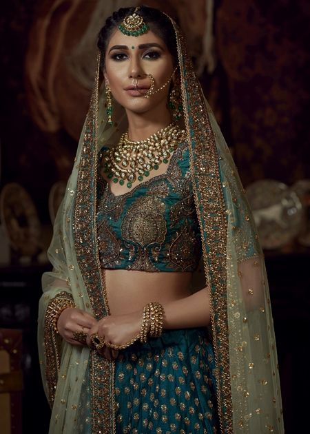 Photo of Teal bridal lehenga with gold work