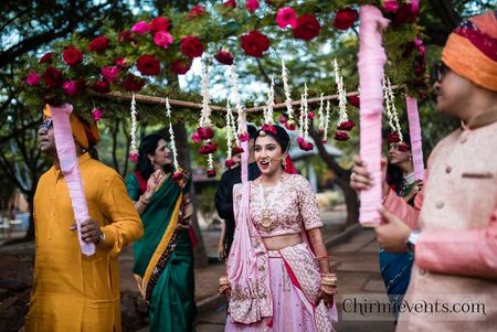 Bride entering under Phoolon ki chadar