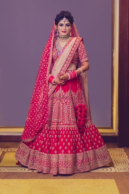 Photo of Red bridal lehenga with dull gold embroidery