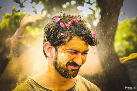 Fun shot of a groom to be at a haldi function