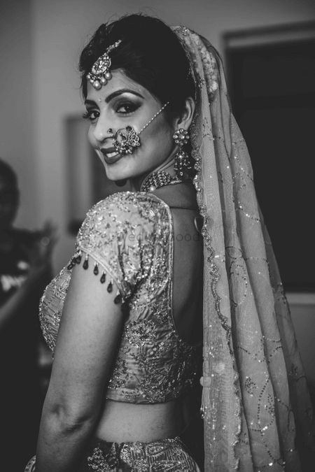 Black and white bridal portrait looking back 