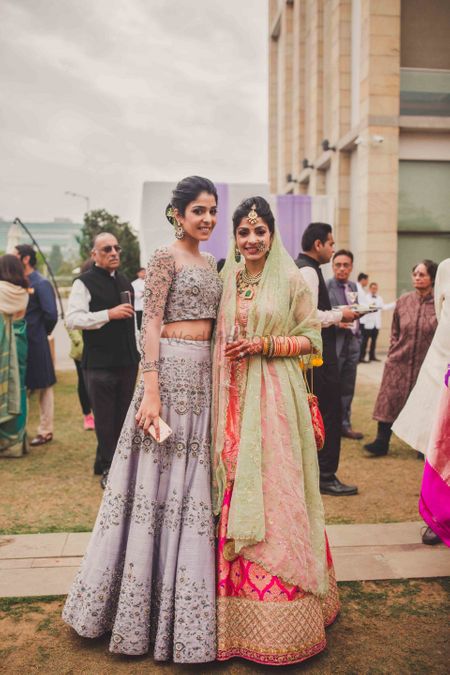 Bride with bridesmaid in dirty lilac lehenga 
