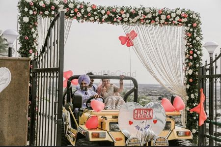 Couple exit in just married car 