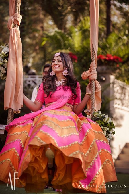 Photo of Mehendi day bridal portrait with bride on swing