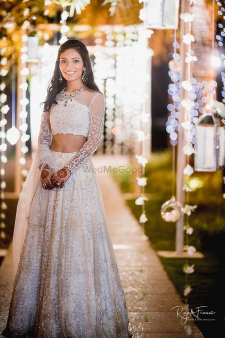Beautiful white lehenga with a sheer blouse for engagement