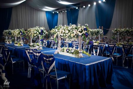 Photo of joined table centerpieces . floral cneterpieces
